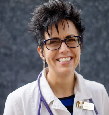 A woman with glasses and a stethoscope around her neck.